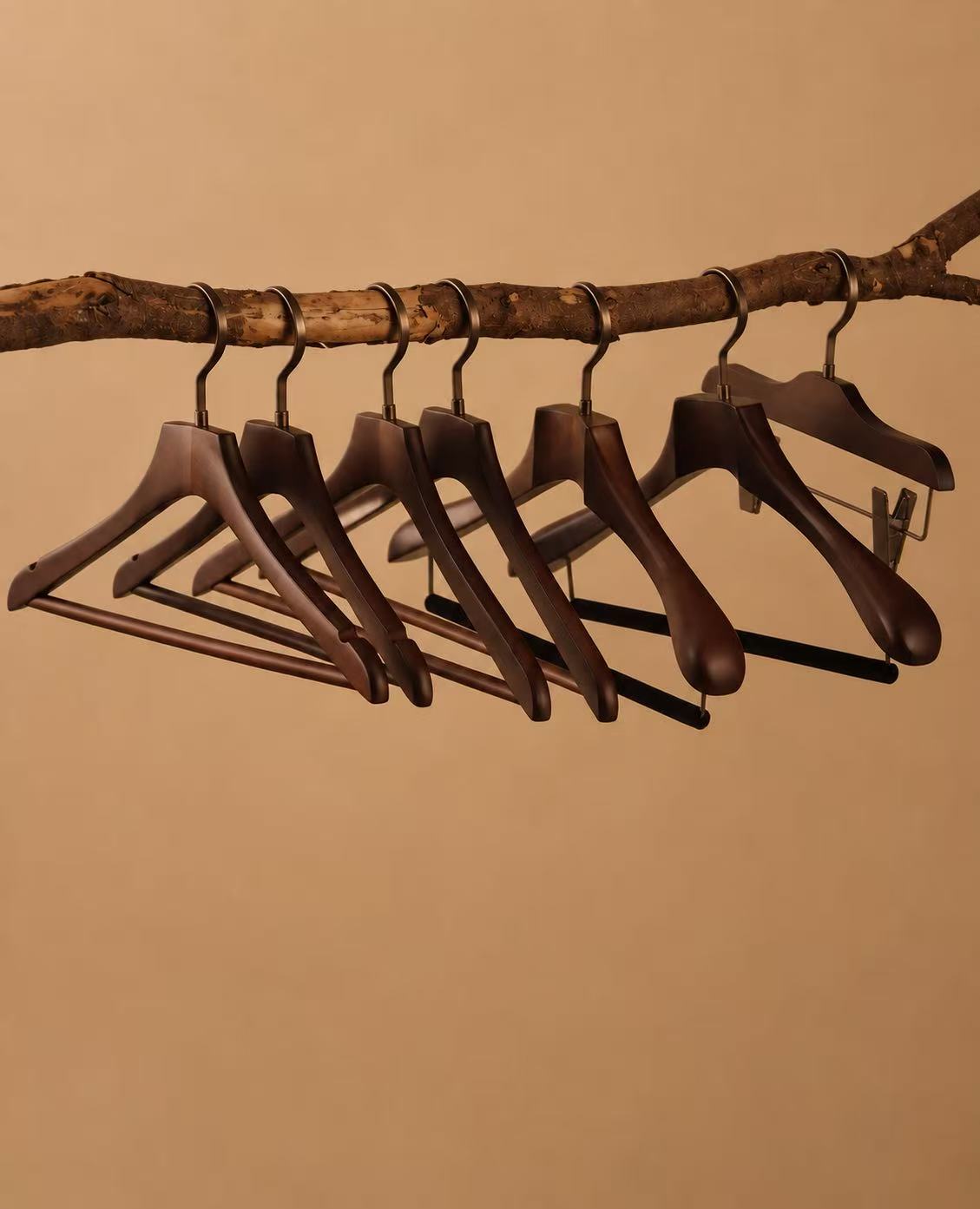 A collection of premium custom wooden hangers with varied profiles and hardware options.