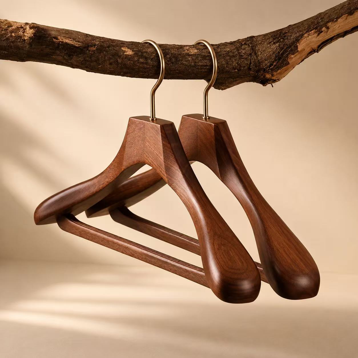 Premium walnut-finish wooden hangers for global fashion brand presentation.