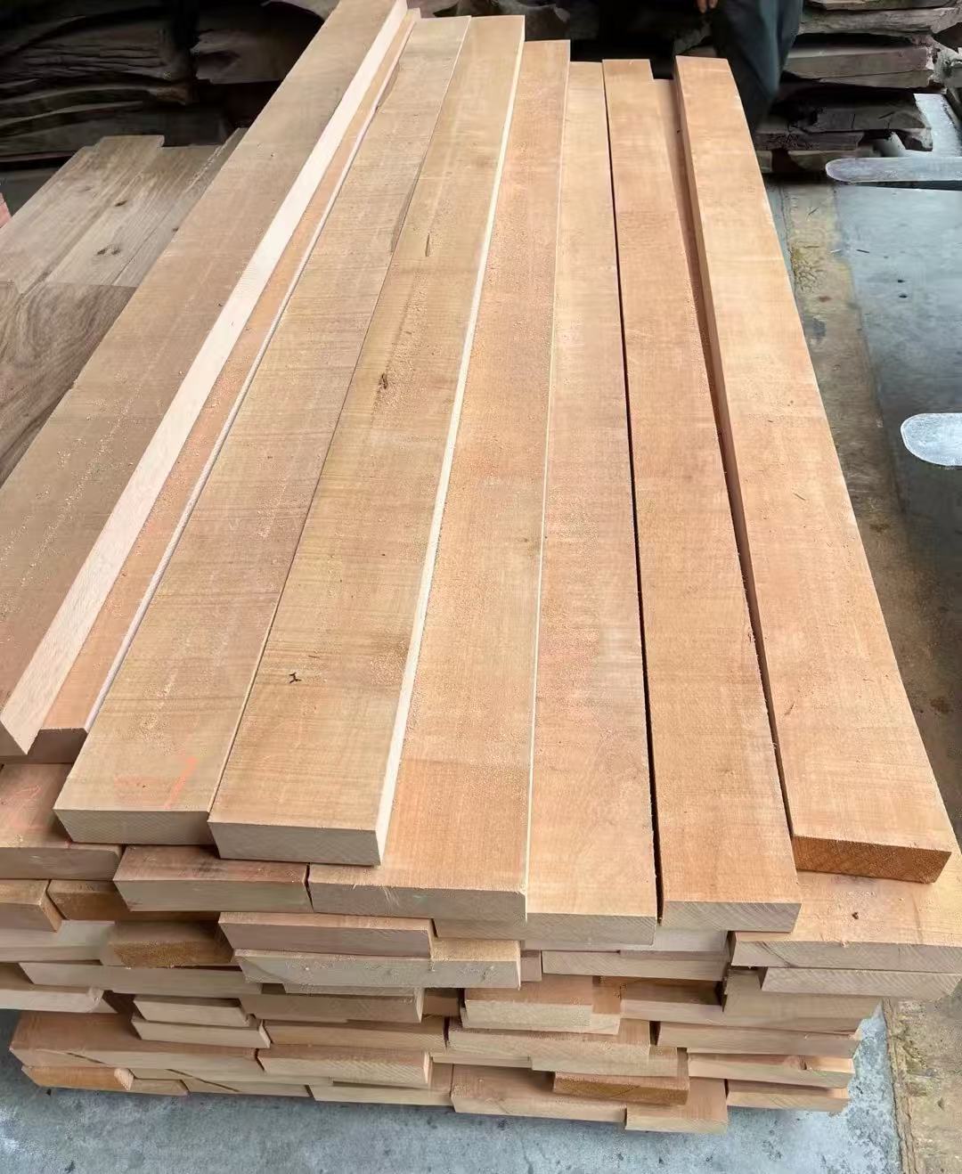 Solid wood boards stacked in the workshop.